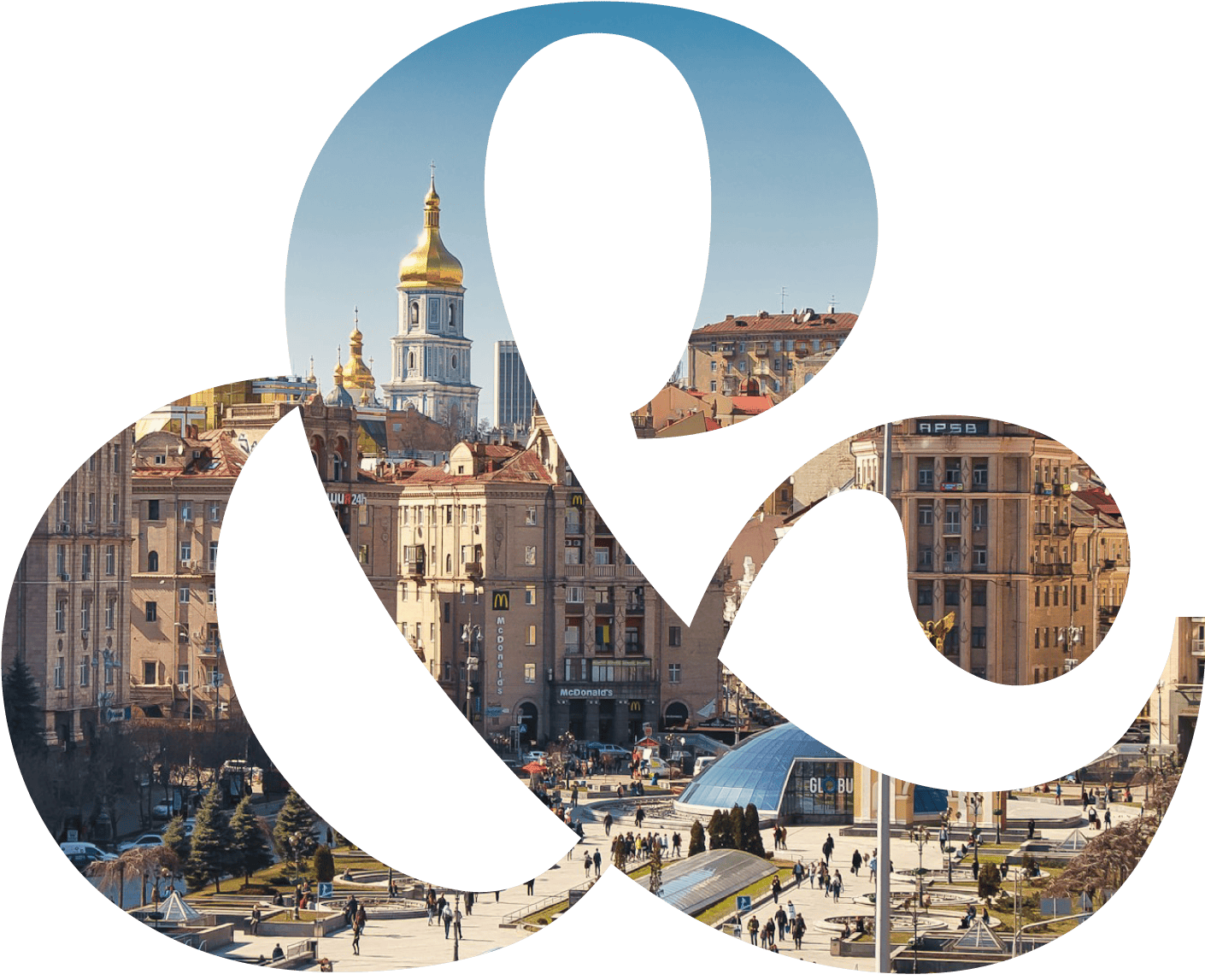 City square with people walking, featuring golden-domed cathedral and historic buildings in the background.